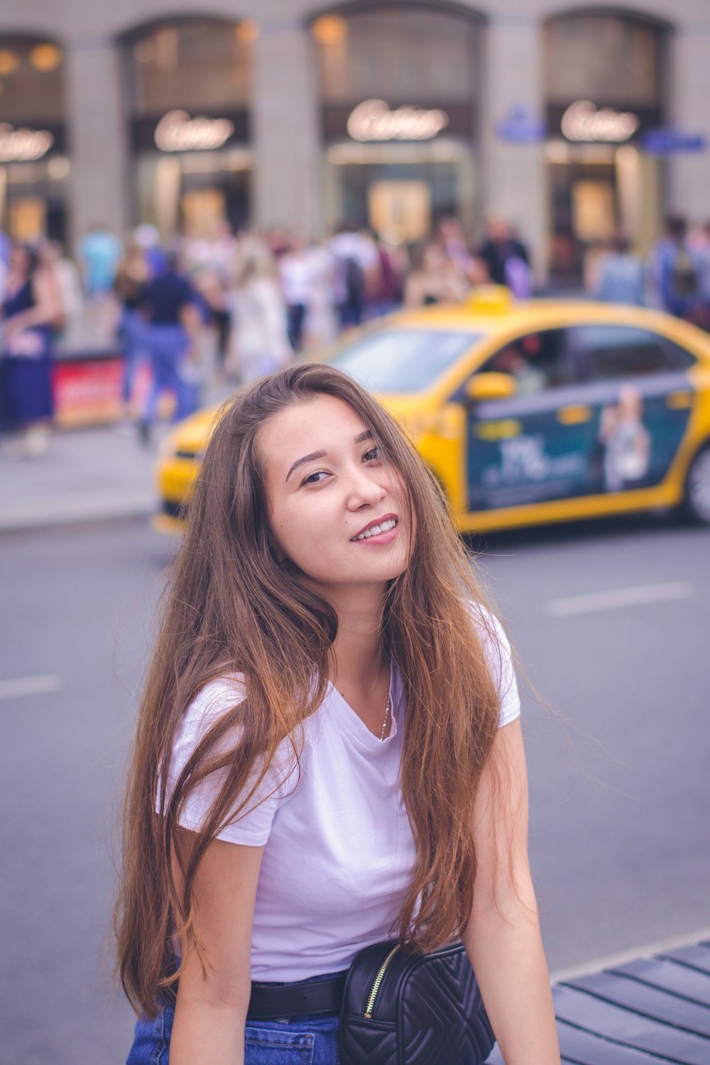 person taking picture woman in white scoop-neck shirt