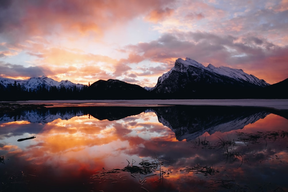 body of water in front of mountain ranges