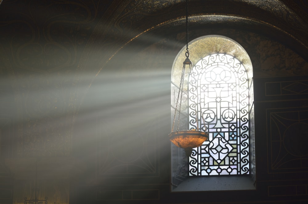 brown pendant lamp beside window