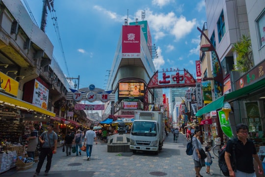 white box truck beside building in Ameyoko market Japan