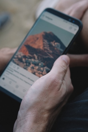 An engaging social media post displayed on a smartphone with a Croydon landmark.