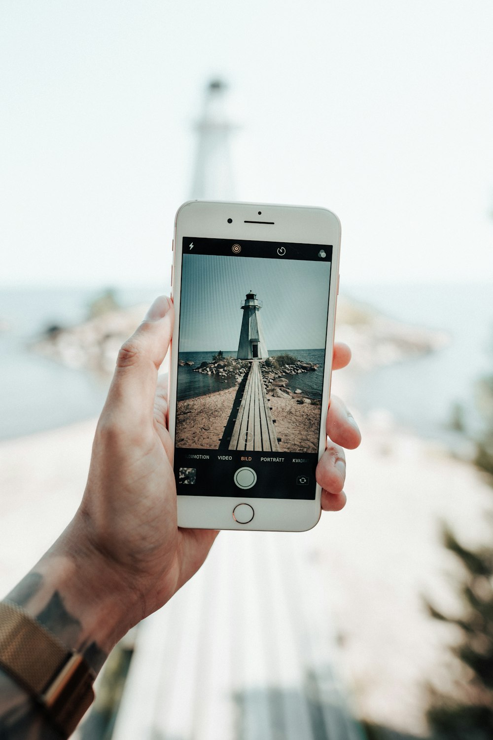 white lighthouse through phone