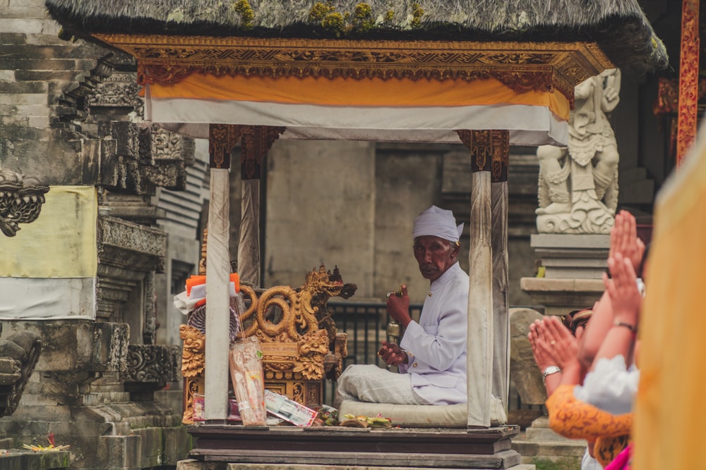 man sitting in front of dragon figurine