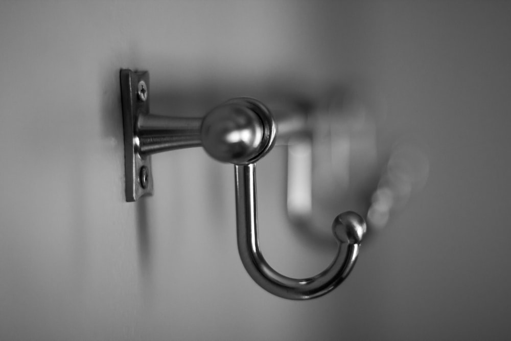 gray scale photo of door lever