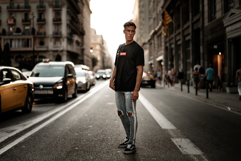 man standing on asphalt road