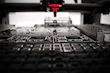 Engineer working on electronic circuit board with precision tools
