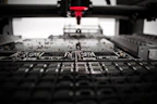 Engineer working on electronic circuit board with precision tools