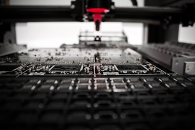 Technicians assembling electronic components with precision tools.