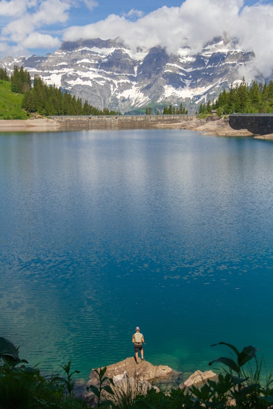 man standing in front of body of water in Glarus Switzerland