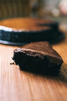 Close-up of a delicious homemade chocolate cake with glossy frosting on a rustic wooden table
