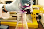person pouring purple liquid on clear glass container