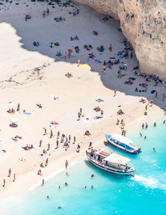 two boats near peoples in Navagio Greece