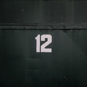 12-printed on black steel gate