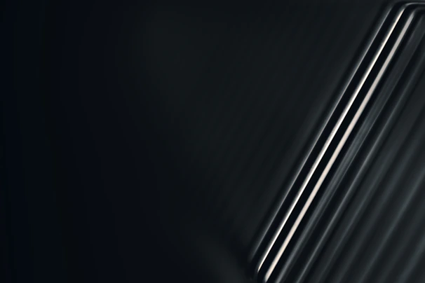 Artistic photo of polished aluminum rods with elegant lighting emphasizing texture