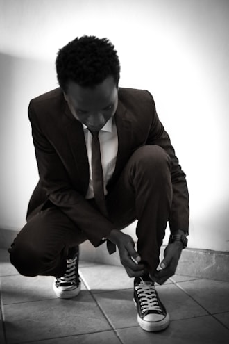 man tying his shoe lace