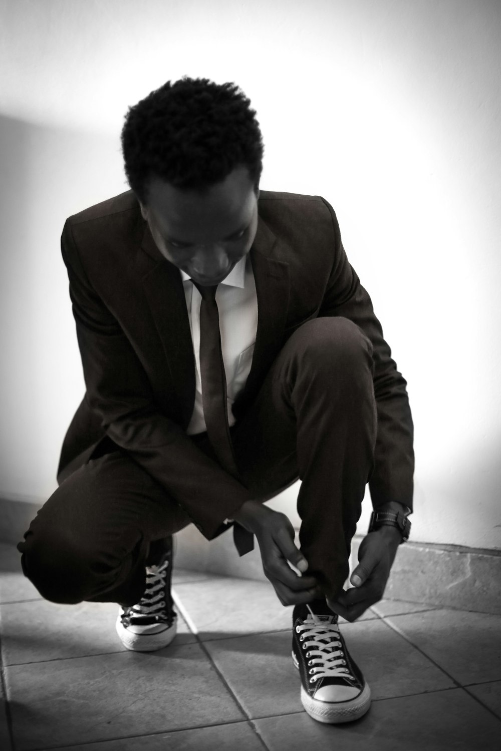 man tying his shoe lace