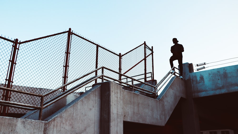 man stand on stair railing