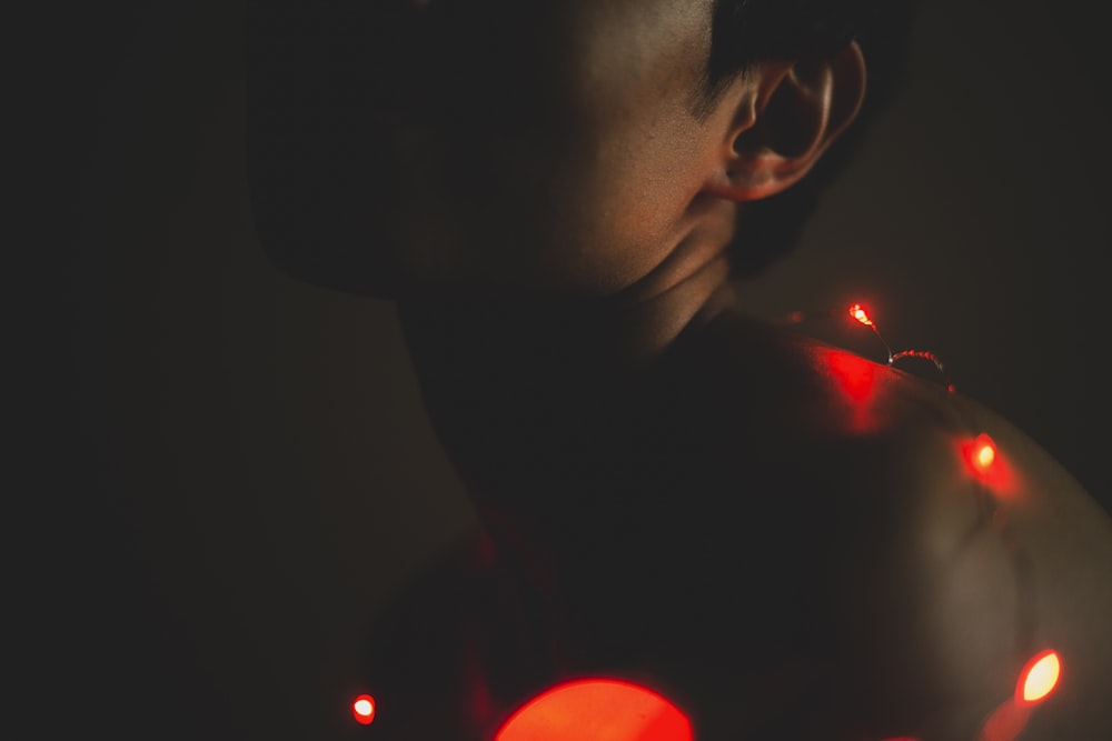 person surrounded their body with lighted string lights