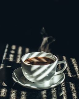 white teacup filled with tea