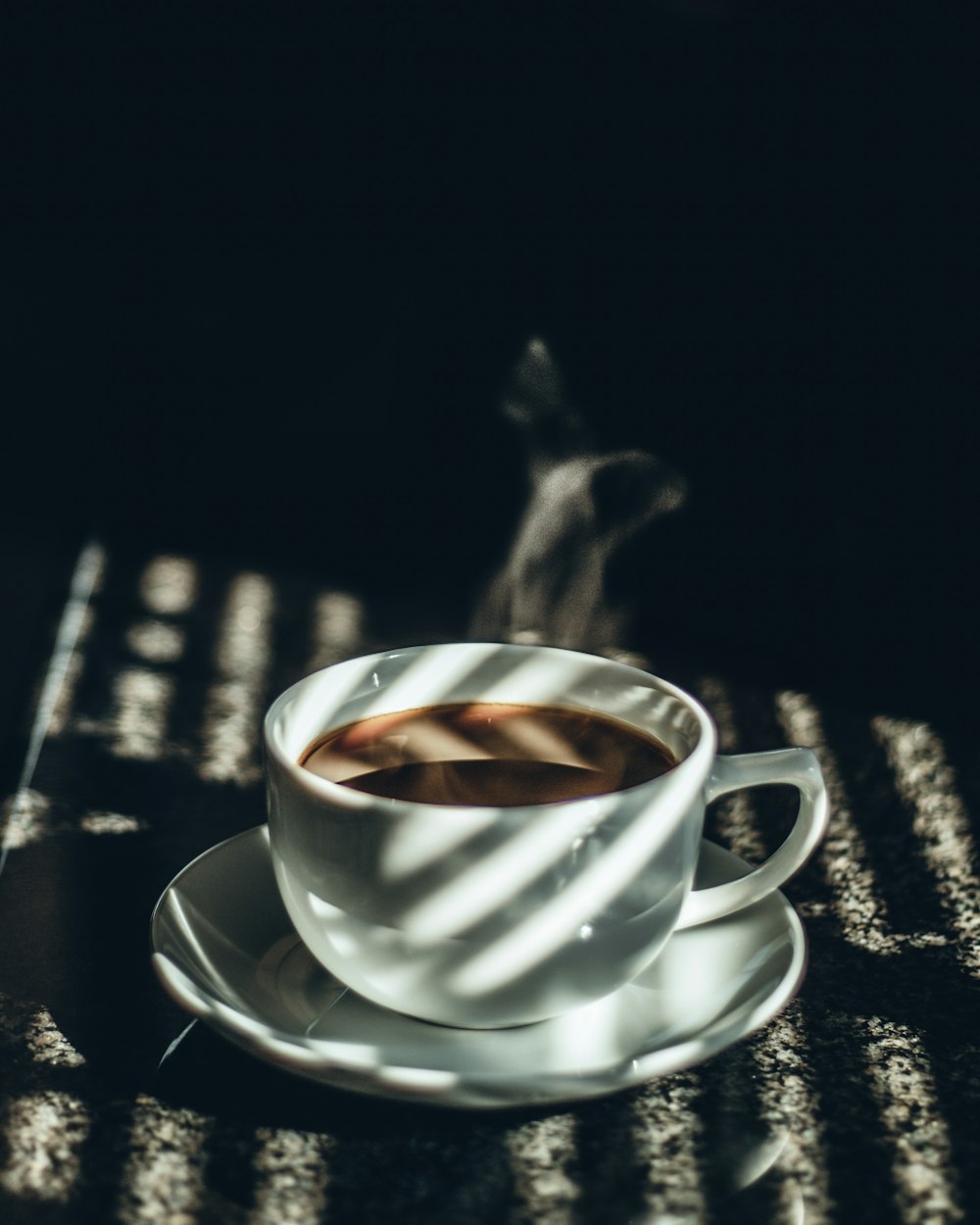 white teacup filled with tea