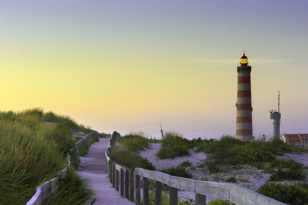 gray pathway near lighthouse