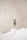 white flowers in white ceramic vase on top of white table