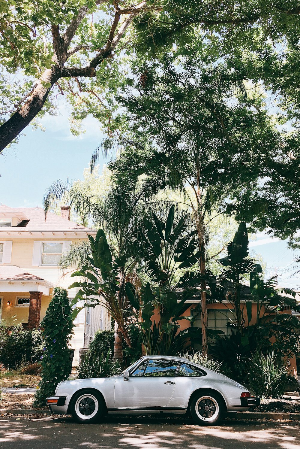 white coupe on gray concrete ground