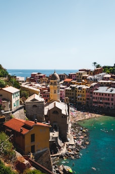 A vibrant Caribbean coastal town with colorful buildings and clear blue skies.