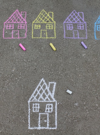 assorted-color house illustration on gray concrete surface