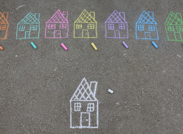 assorted-color house illustration on gray concrete surface