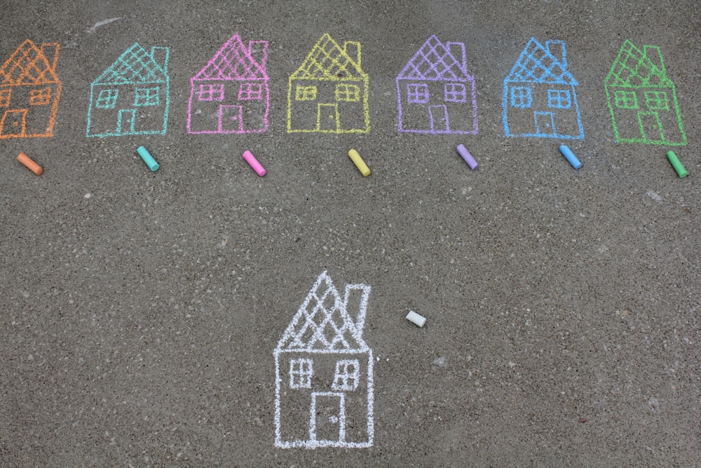 assorted-color house illustration on gray concrete surface