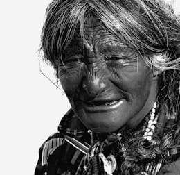 An elderly person meditating peacefully.