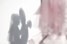 Soft-focused shot of overlapping silhouettes of people without visible faces in soothing blue shades.