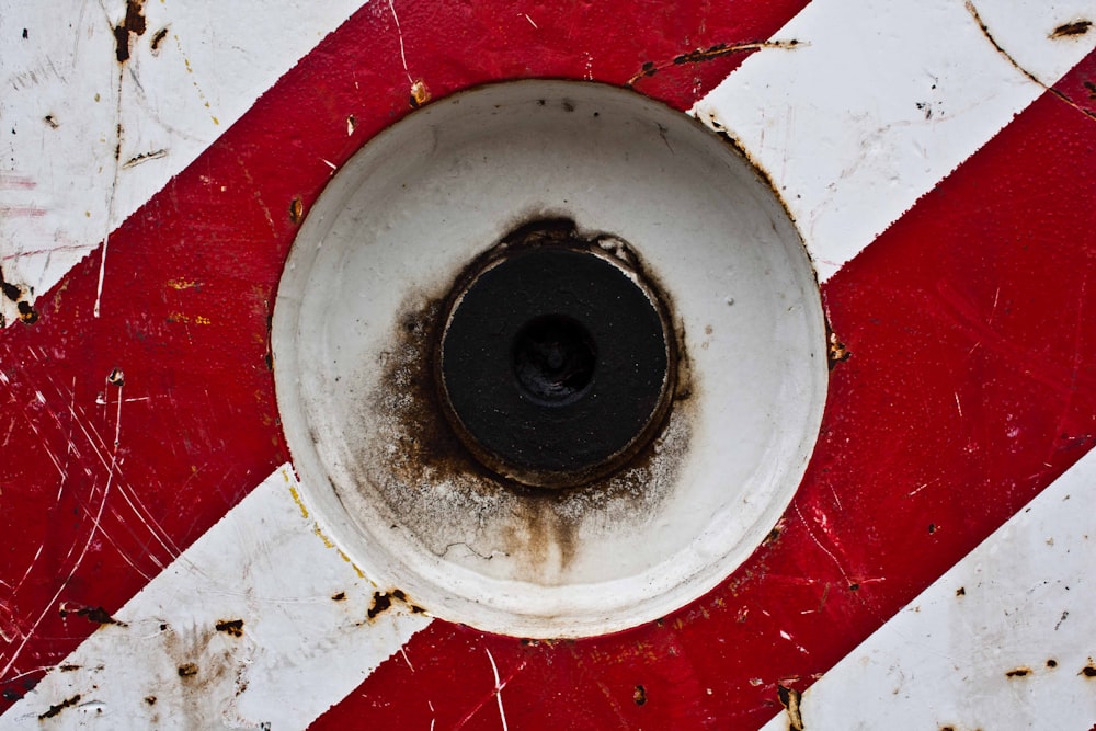 round white steel container on red surface