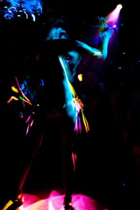 A vibrant music video scene with colorful lighting and expressive dancers.