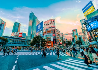 people walking on street under cloudy sky