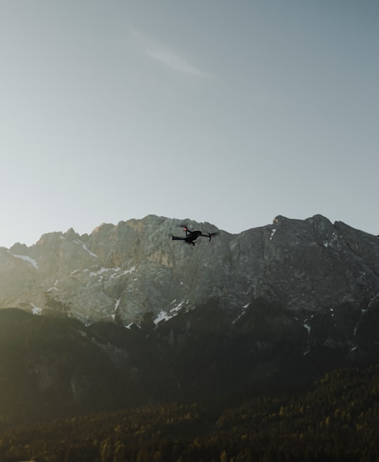 flaying black quad-copter drone in Eibsee Germany