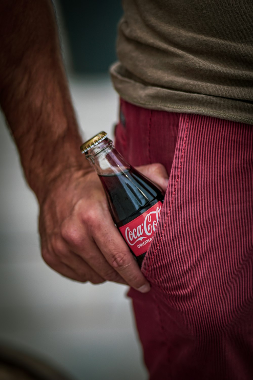 person holding Coca Cola bottle