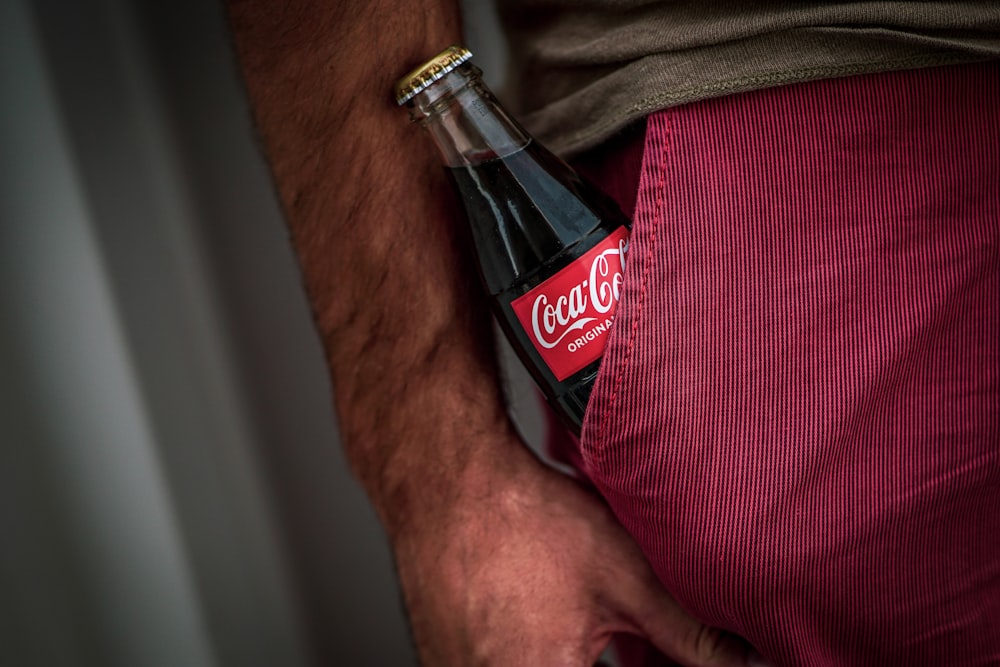 Coca-Cola bottle on red bottoms pocket