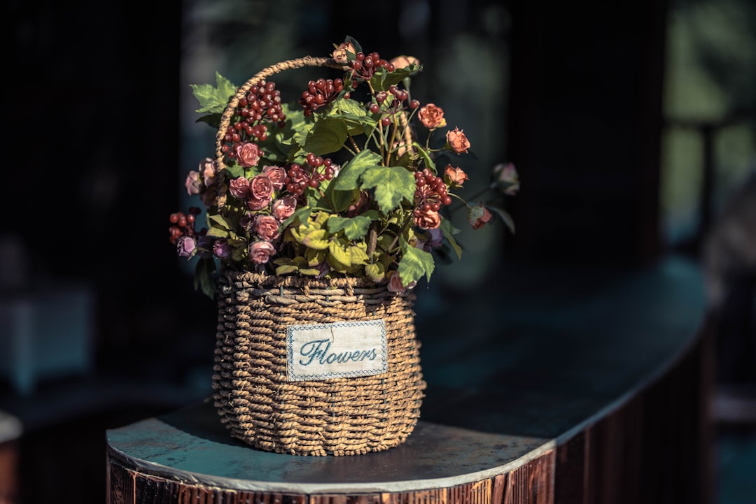red flowers on brown wicker basket