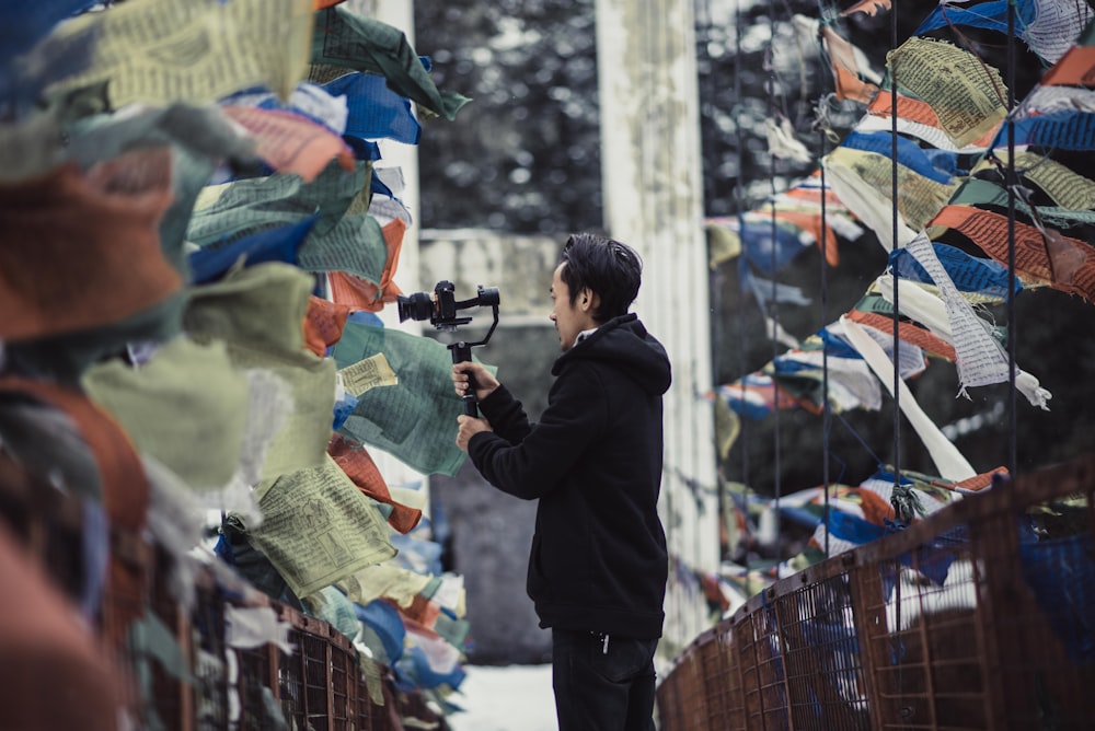 a man standing in front of a bunch of flags