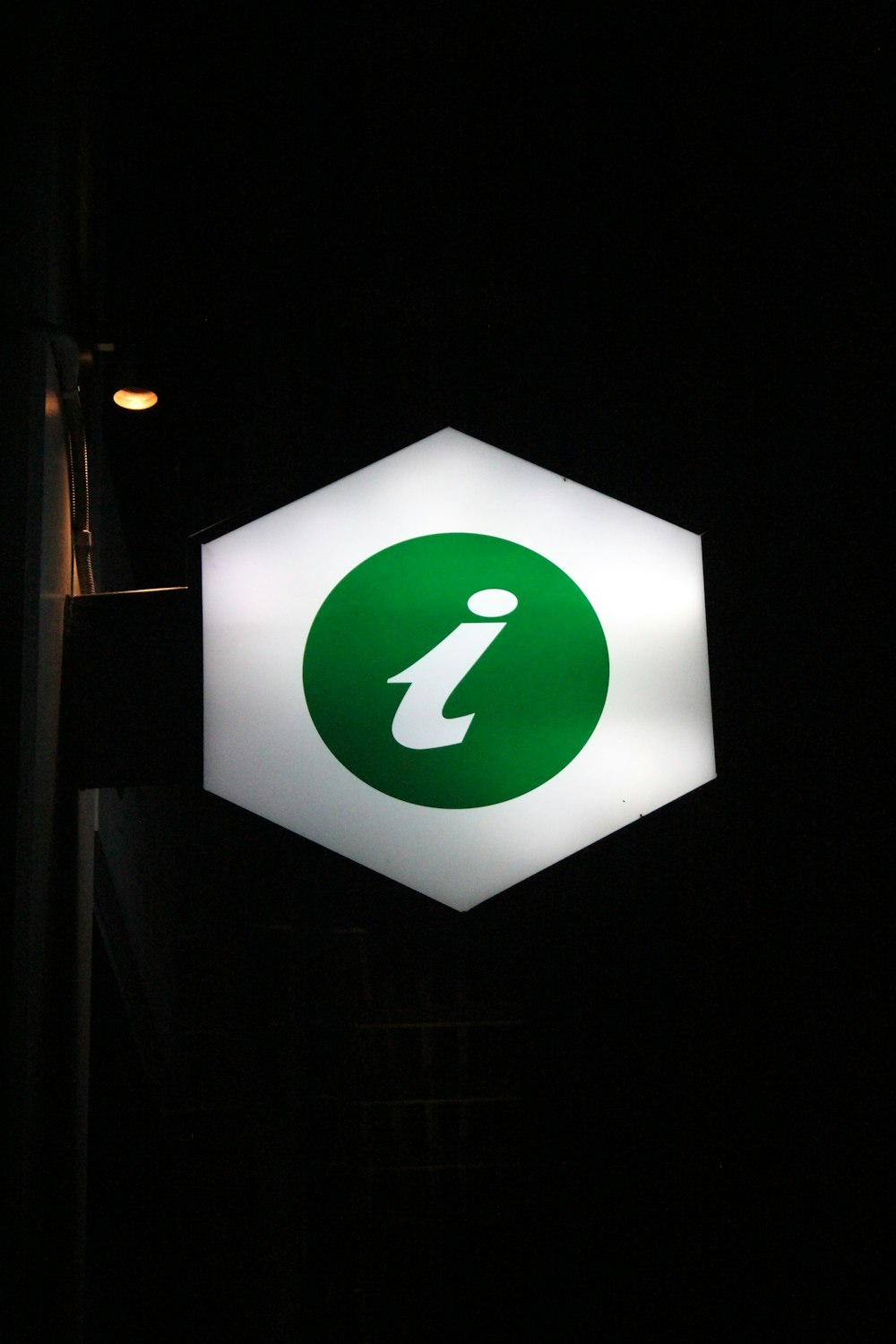 white and green light signage on street during daytime