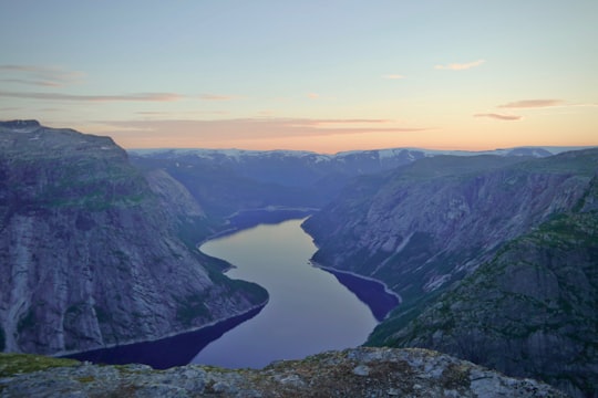 aerial view of lake between mountains in Trolltunga Norway