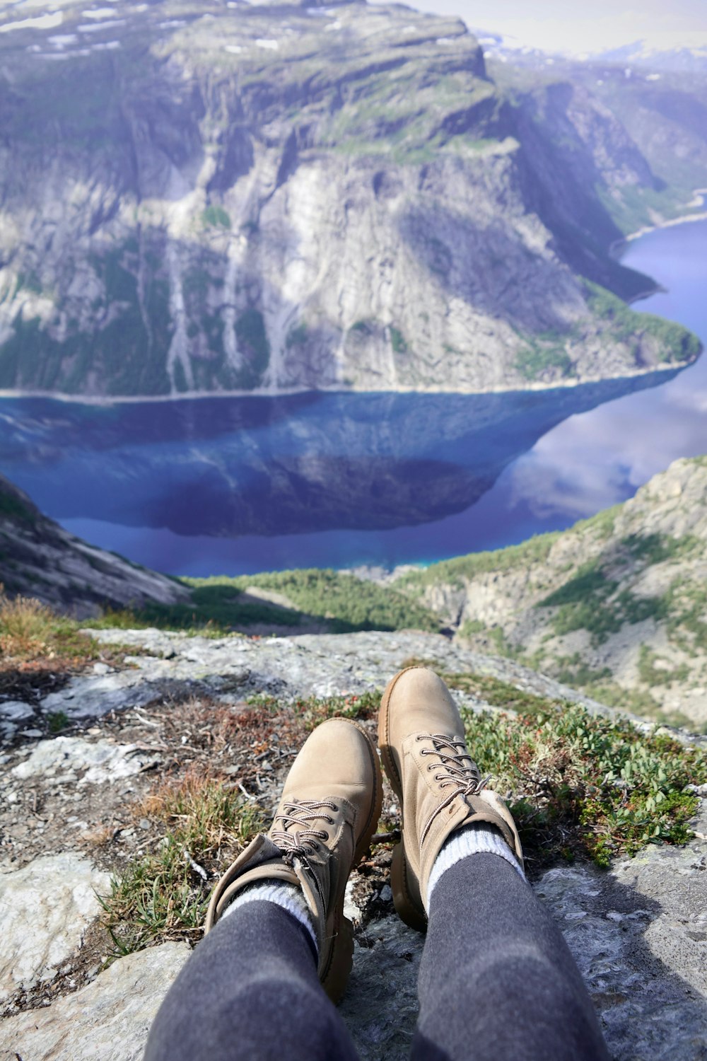 man in brown leather boots on mountain