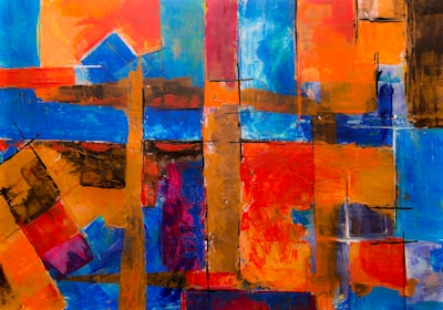 An abstract painting featuring a vibrant mix of geometric shapes and bold colors. The composition includes overlapping rectangles and squares in hues of blue, orange, red, and brown. Textures are created with varying brush strokes, adding depth and movement to the artwork.