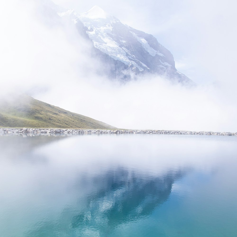 photography of glacier mountain with water reflection