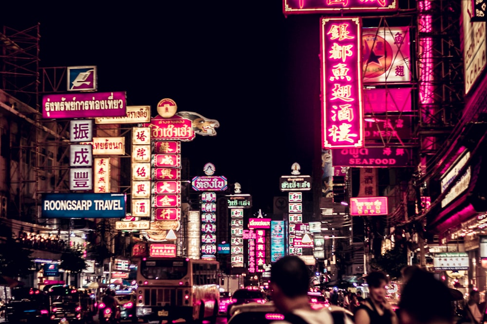 people walking along road filled with LED signages