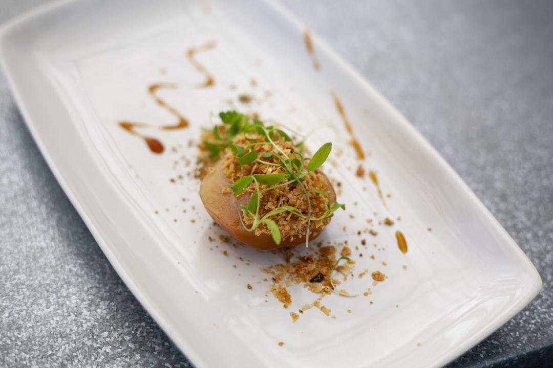 a white plate topped with a piece of food, Haute cuisine dessert