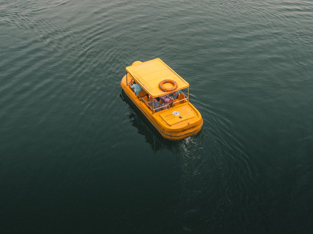bird's eye view photography of yellow boat