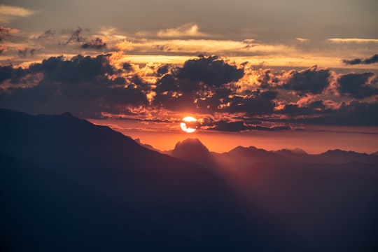 silhouette of mountain under sun in Piz Mundaun Switzerland
